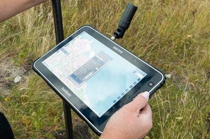 Field surveyor using a rugged RTK data collection tablet